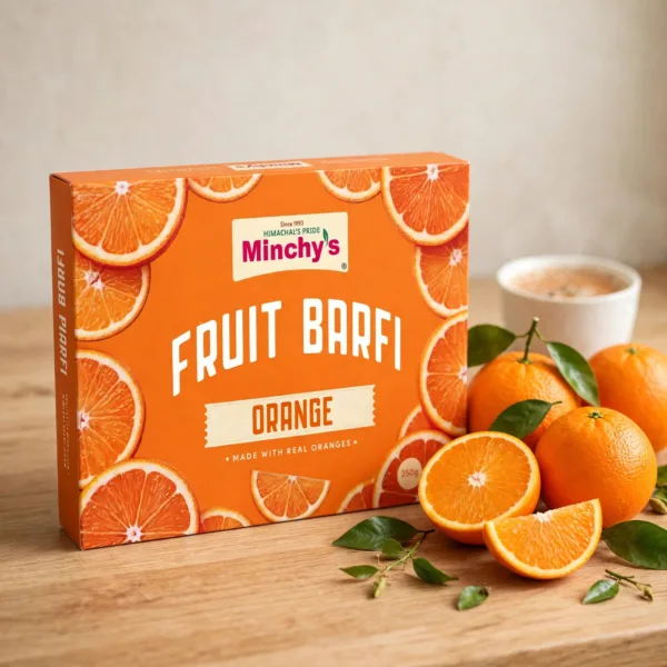 Minchy's Orange Fruit Barfi 250 g box with fresh orange fruit on a wooden board
